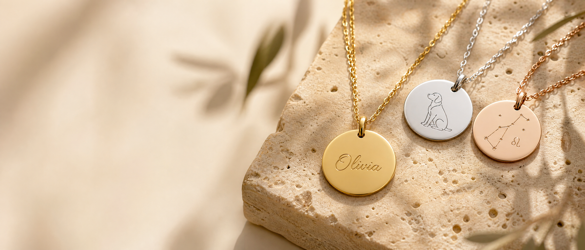Personalised engraved disc necklaces in gold, silver and rose gold on travertine stone