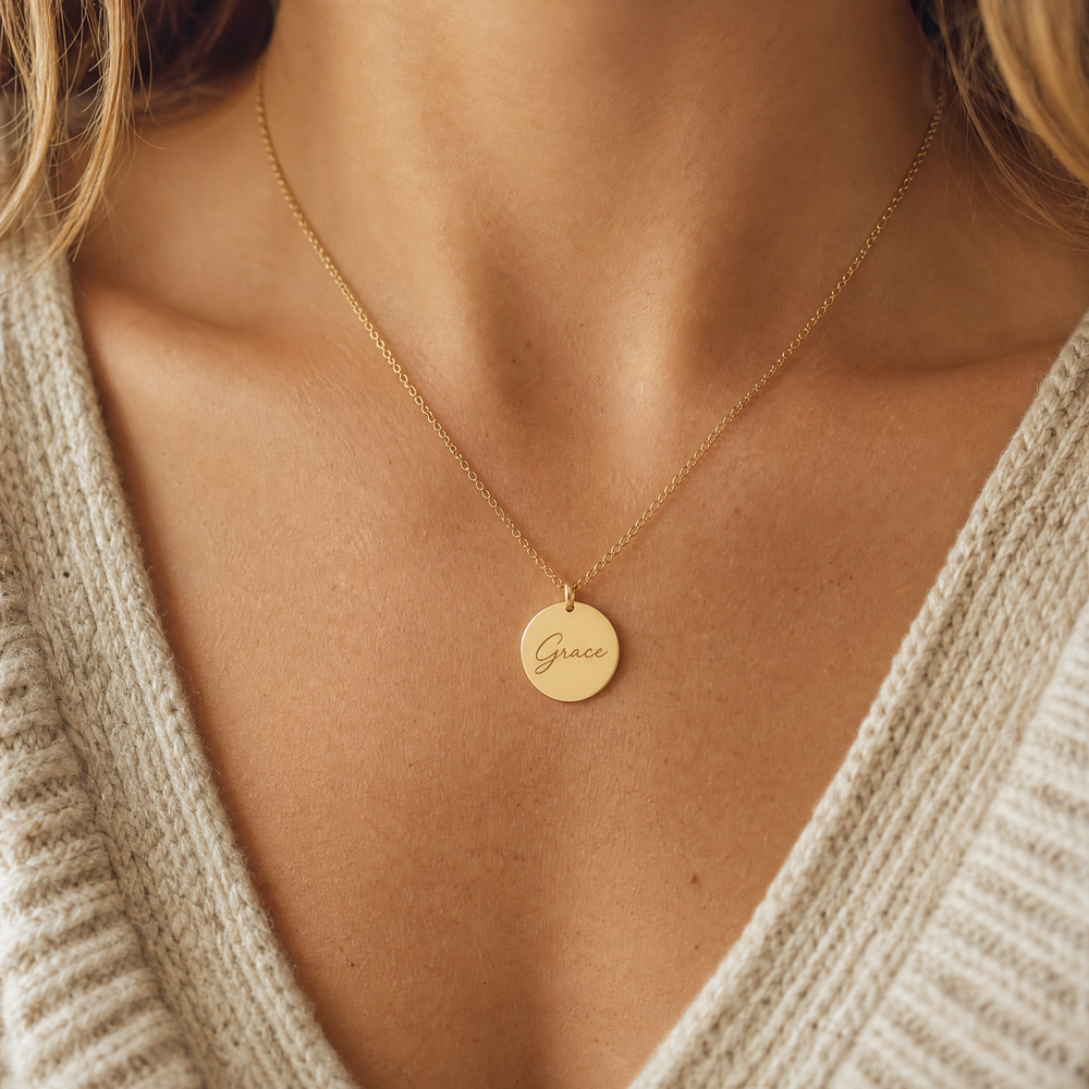 Gold engraved name necklace worn on the collarbone