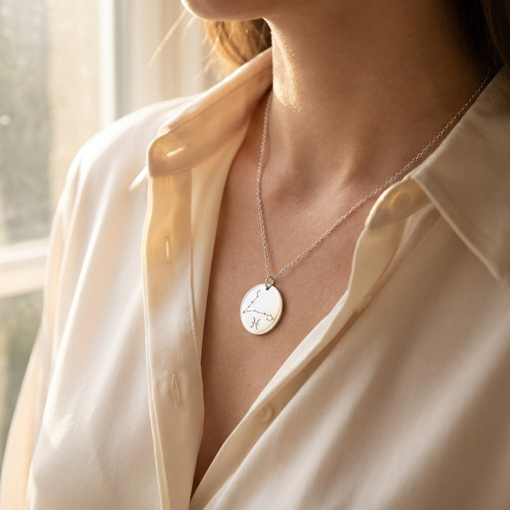 Silver Pisces constellation necklace worn on the collarbone